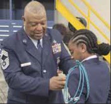 Mercedez Jackson receives her pin from her grandfather Jerome Jackson.